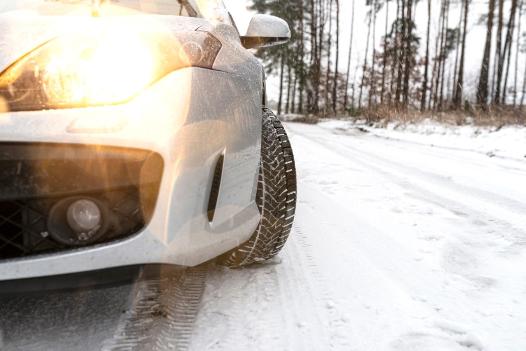 Car headlights in winter snowy road